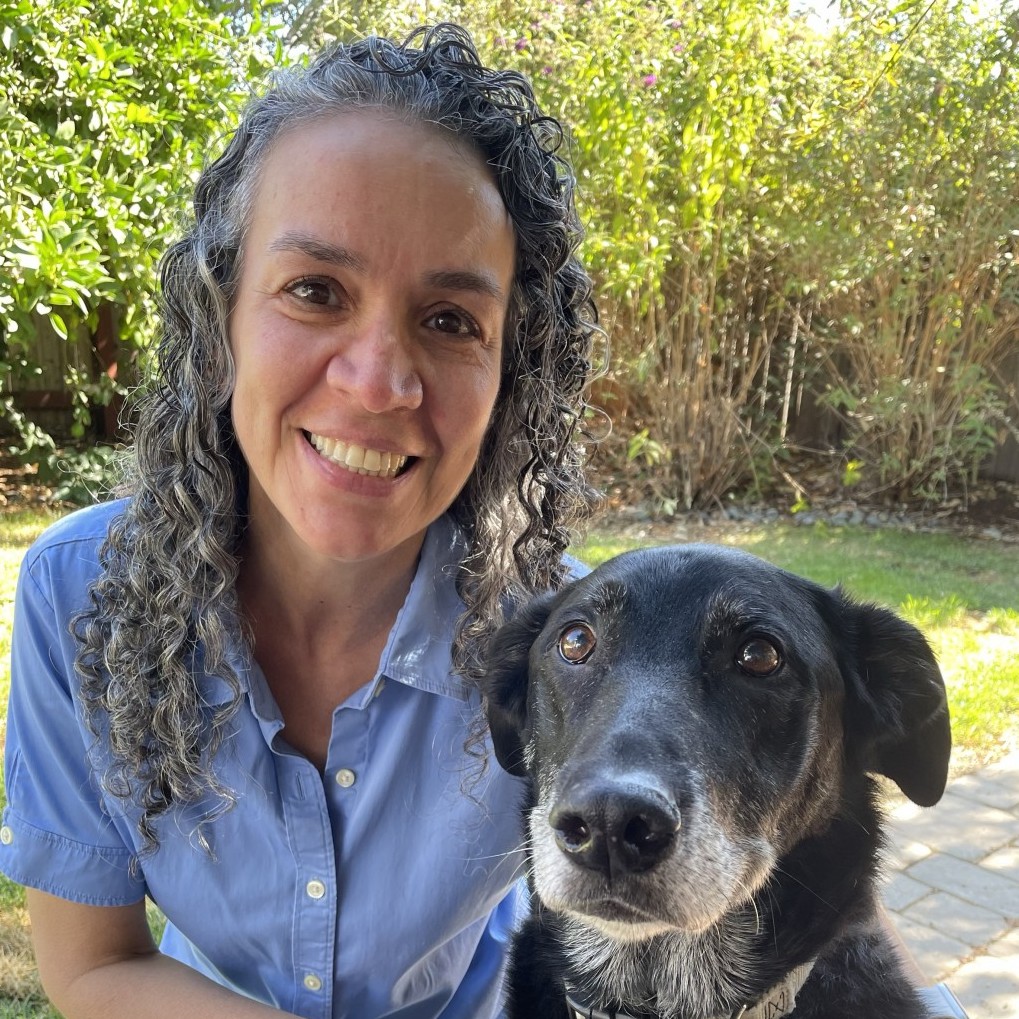 Arlene McKinstry, DVM, CCRP, CVA (she/her/hers) with a black elder dog