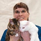 Pam Buckman, RVT holding 2 cats